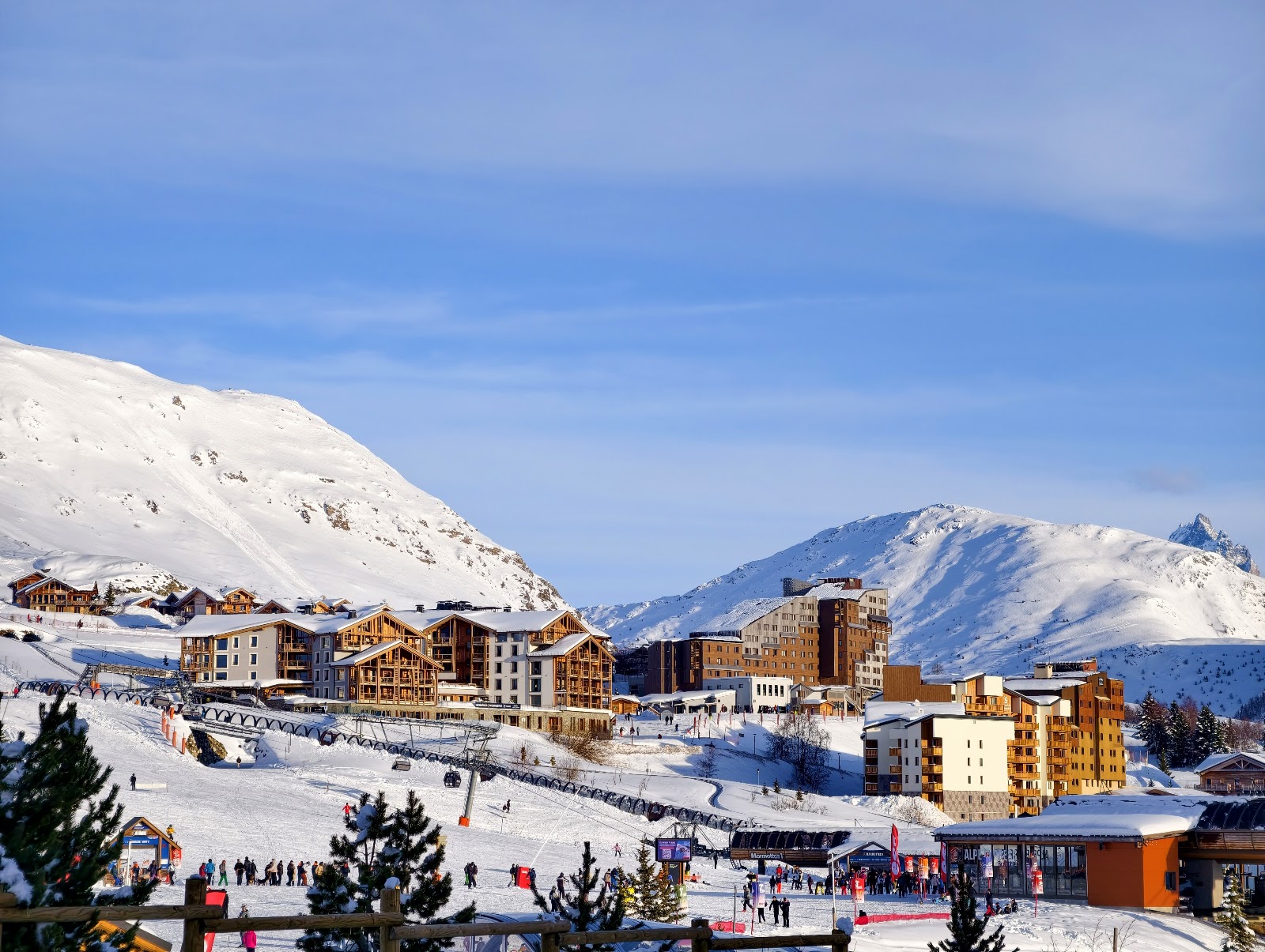 The sunny high altitude resort of Alpe d Huez on a broad plateau surrounded by ski slopes