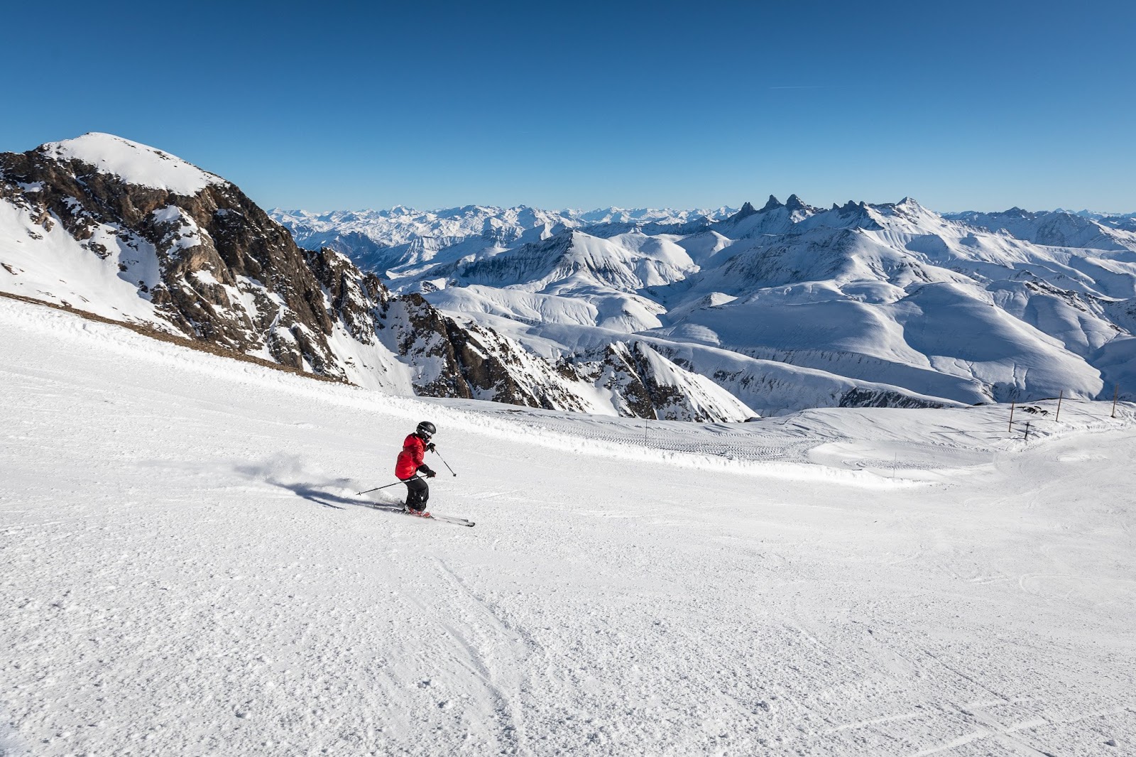 Skiers enjoying apres ski drinks on a sunny mountain terrace