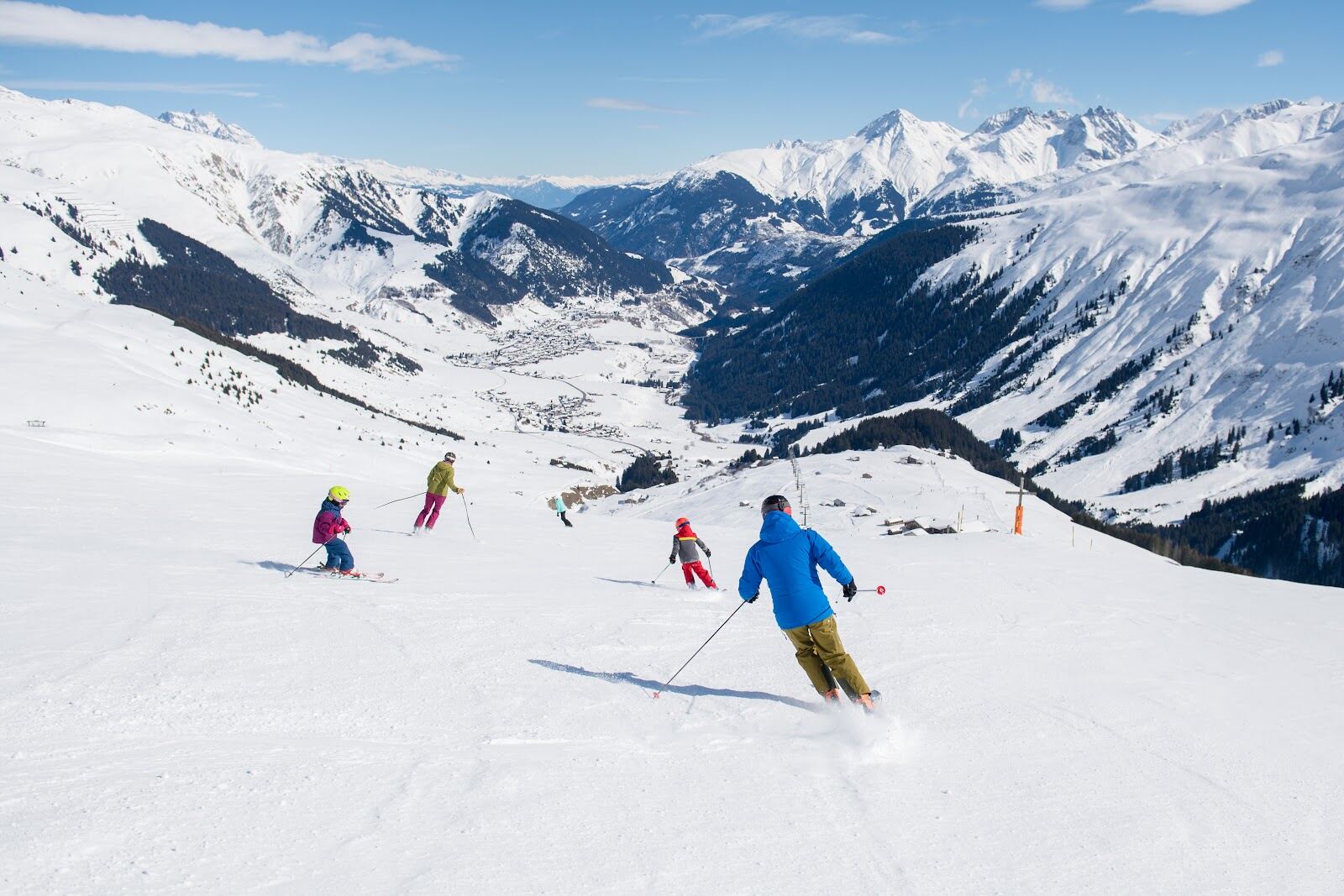 A wide sunny groomed red run on the Sedrun side of Andermatt