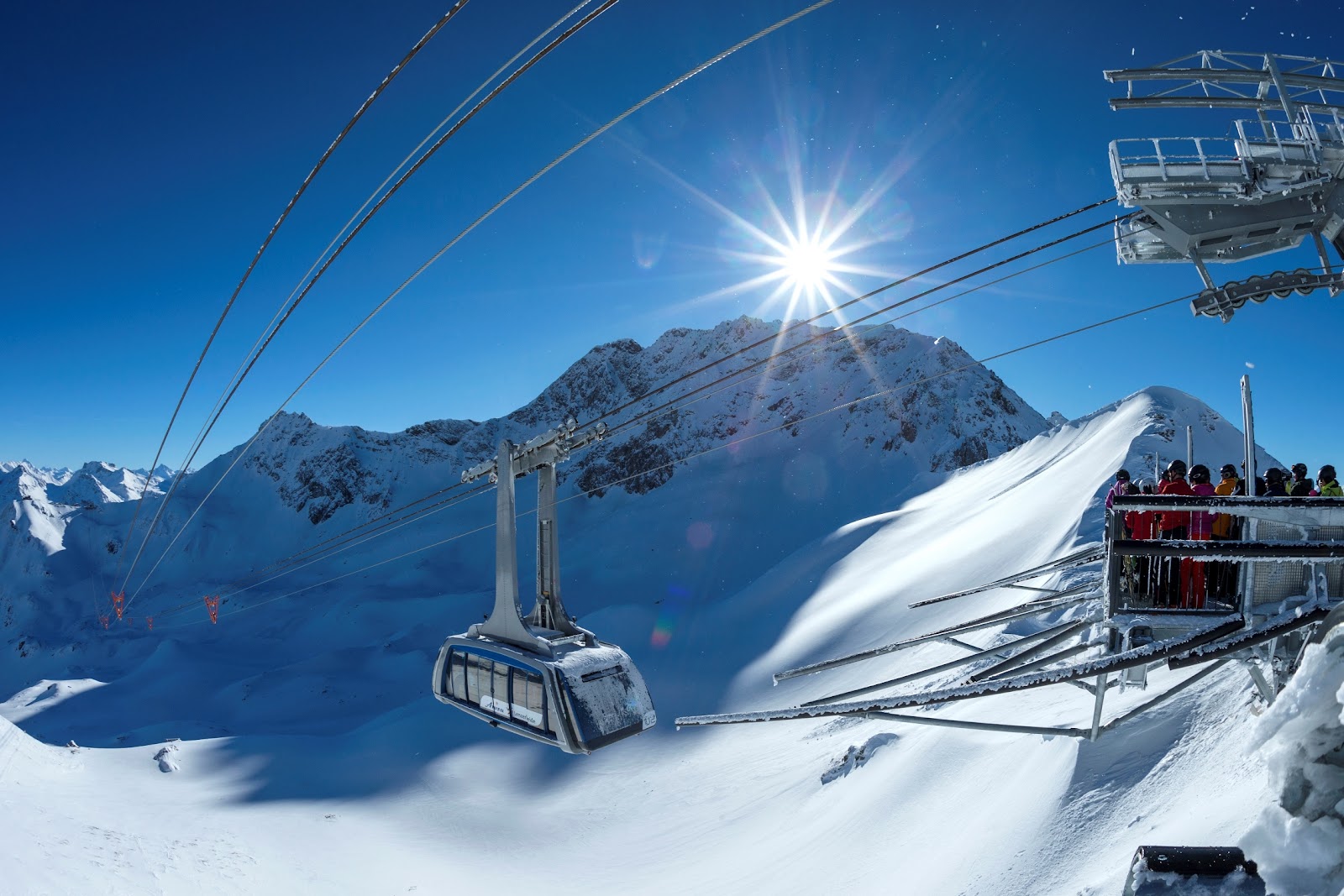 The sunny town of Arosa at the head of its valley in Graubunden with ski slopes above