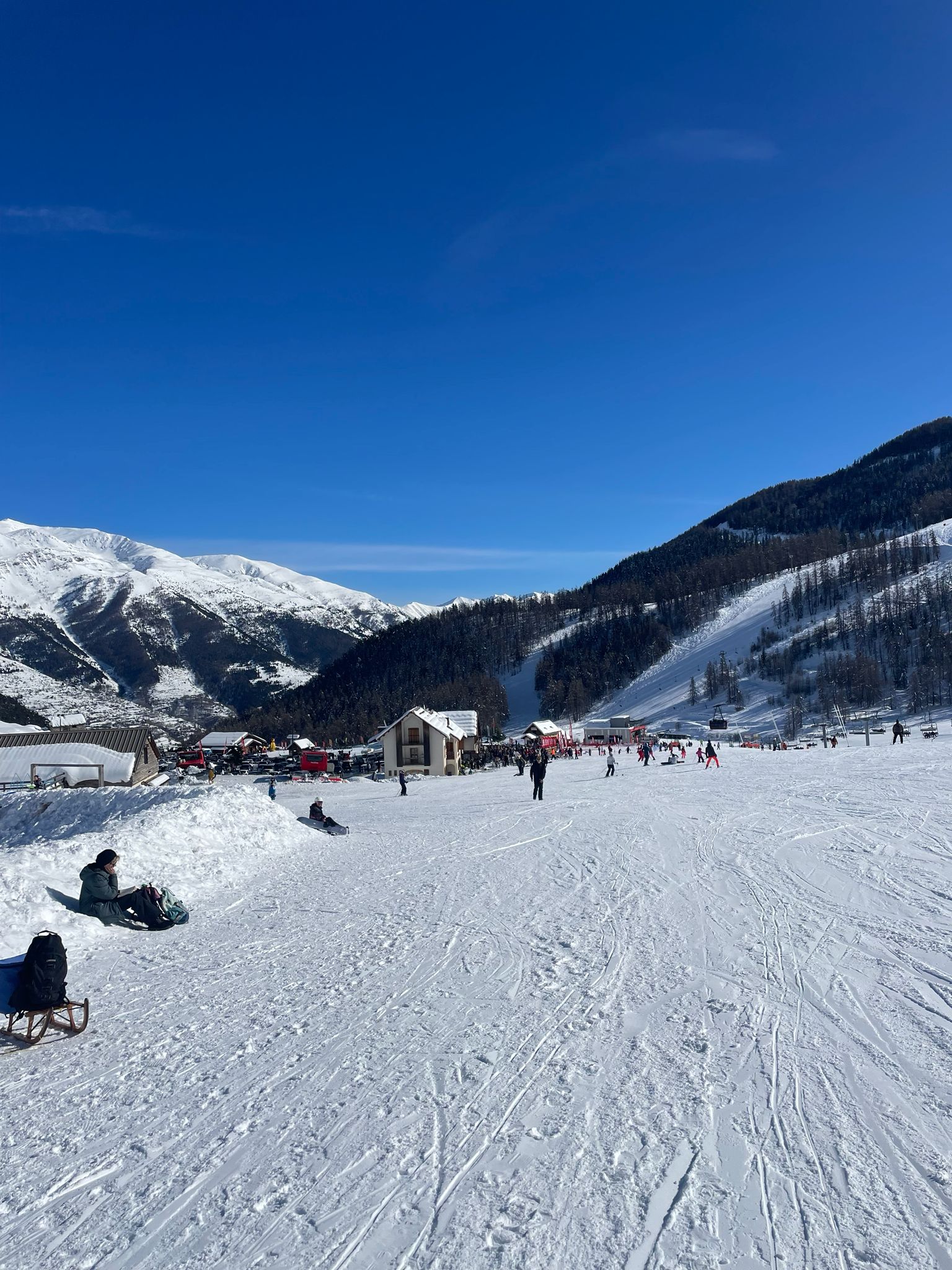 Skiers on a varied red run in the Auron ski area