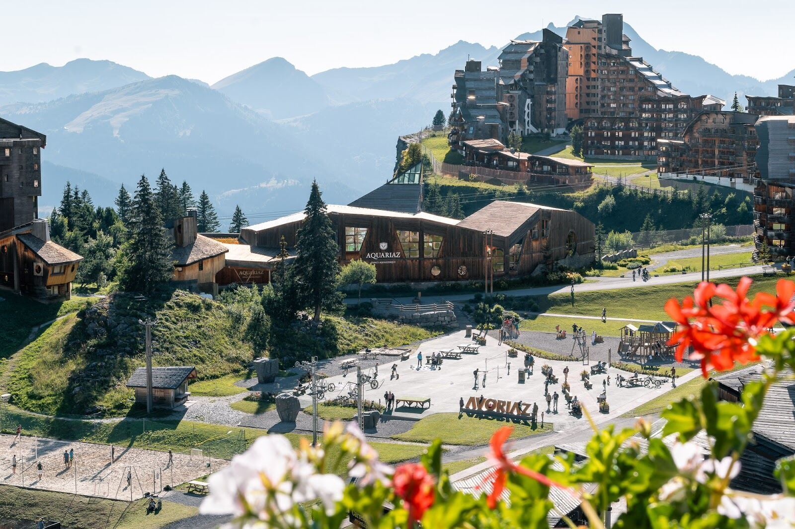Skiers and snowboarders on a sunny piste at Avoriaz