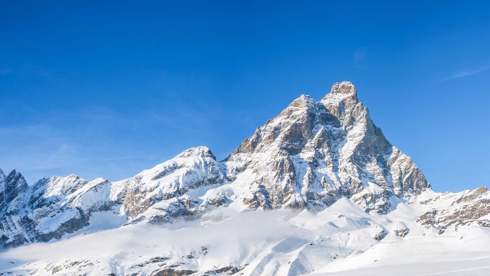 A sunny mountain restaurant terrace above Cervinia with the Matterhorn behind