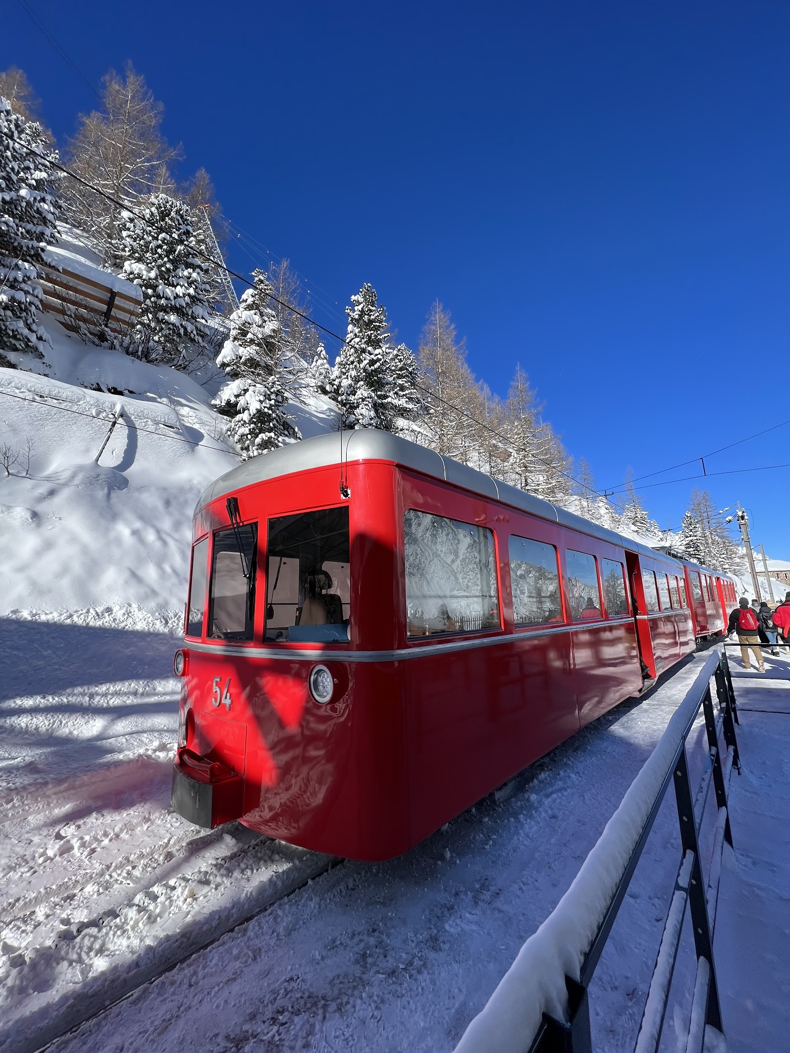 A skier on a steep off piste slope in deep snow