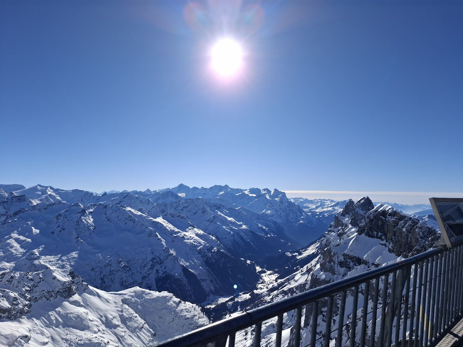 Skiers descending a wide open off piste face below the Titlis glacier
