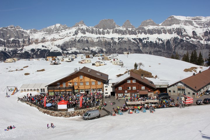 Groomed pistes on the sunny shelf at Flumserberg with the Churfirsten peaks behind