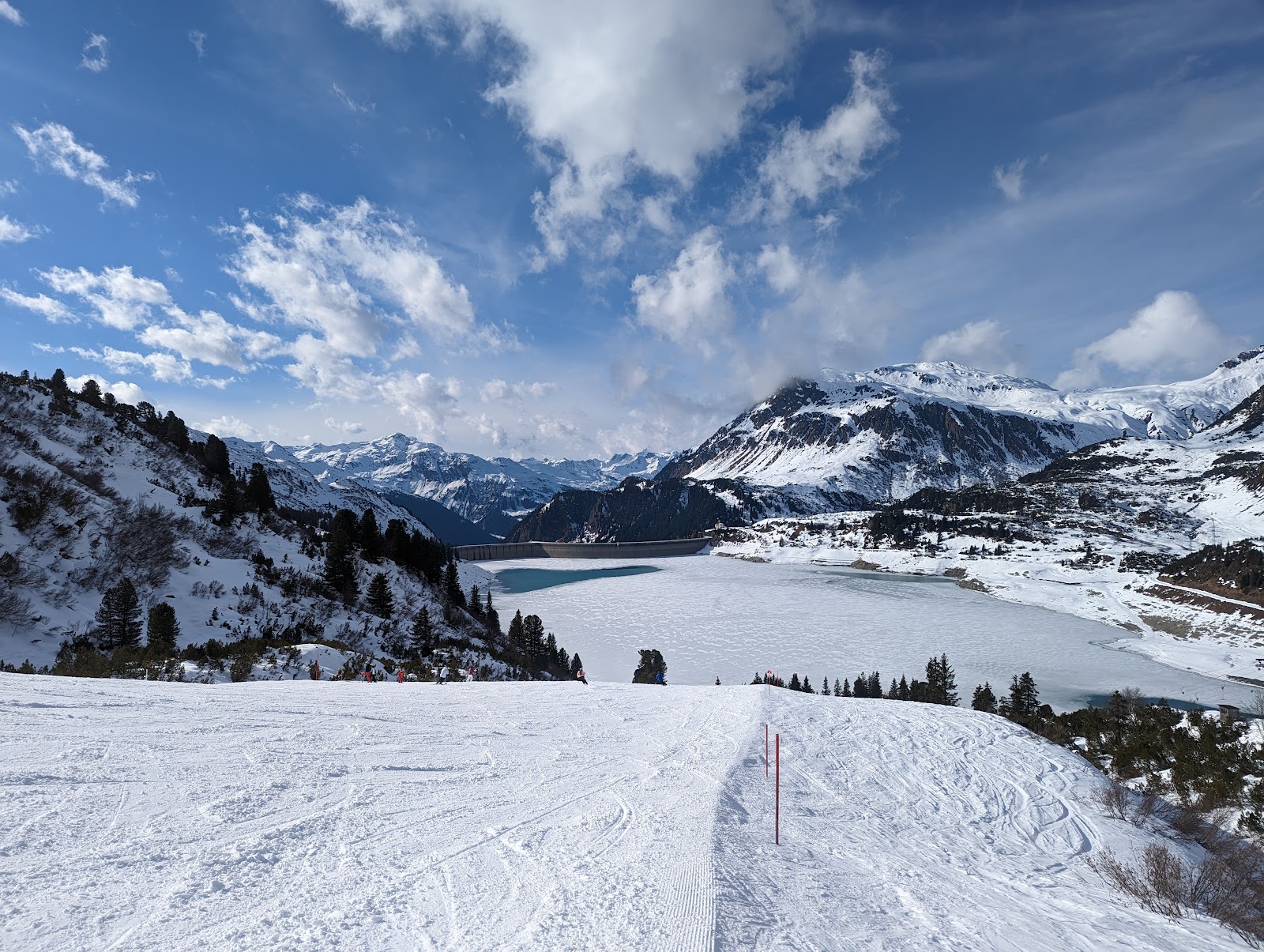 Skiers on a quiet groomed piste above Galtur