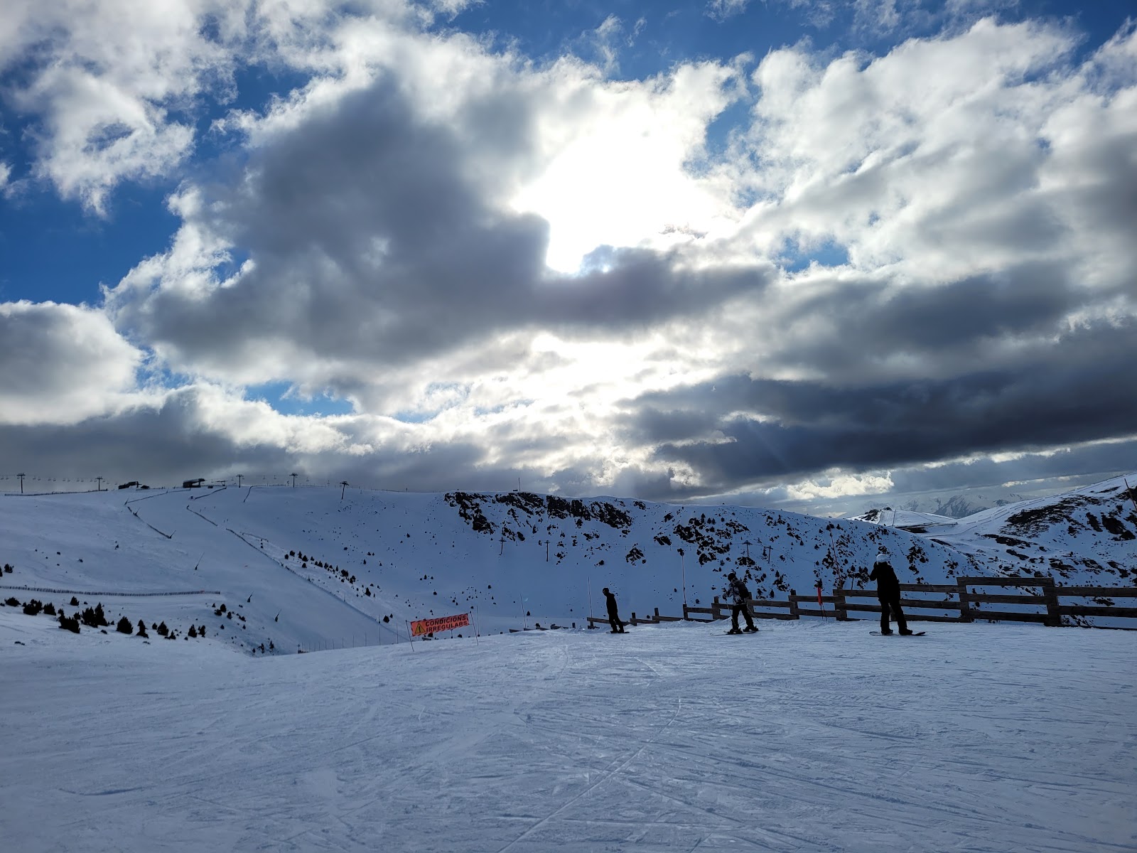 Wide cruising pistes in the Grandvalira ski area under blue sky