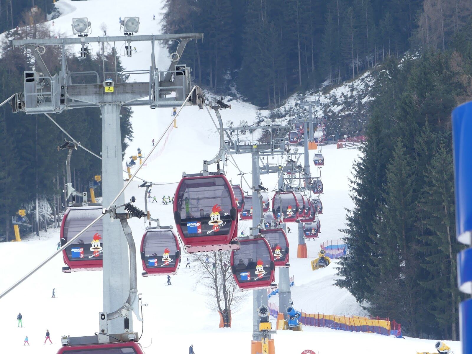 Skiers enjoying sunny well groomed slopes on Plan de Corones