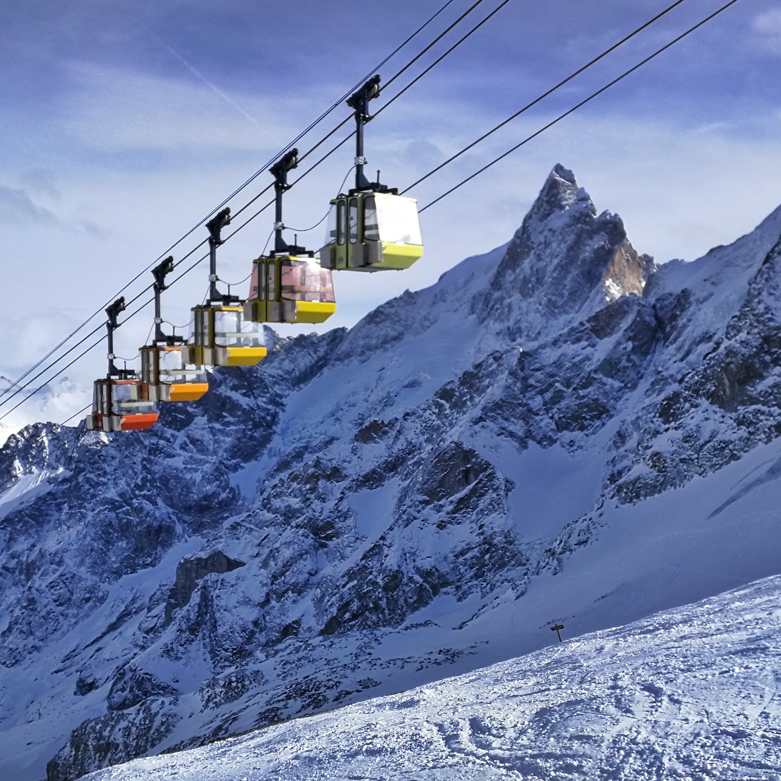 Skiers crossing open glaciated terrain above La Grave