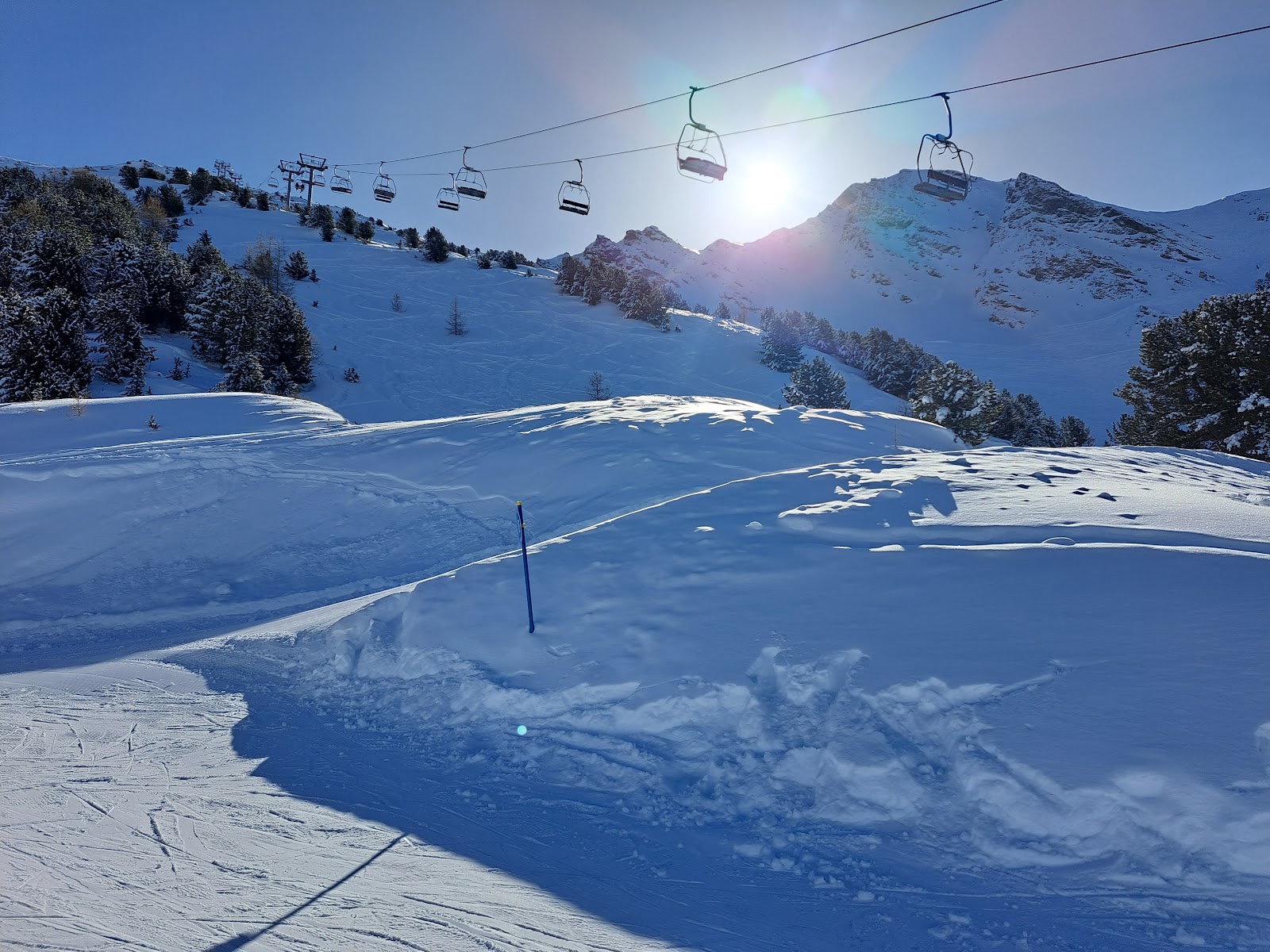 Forest lined ski slopes dropping toward the Maurienne valley
