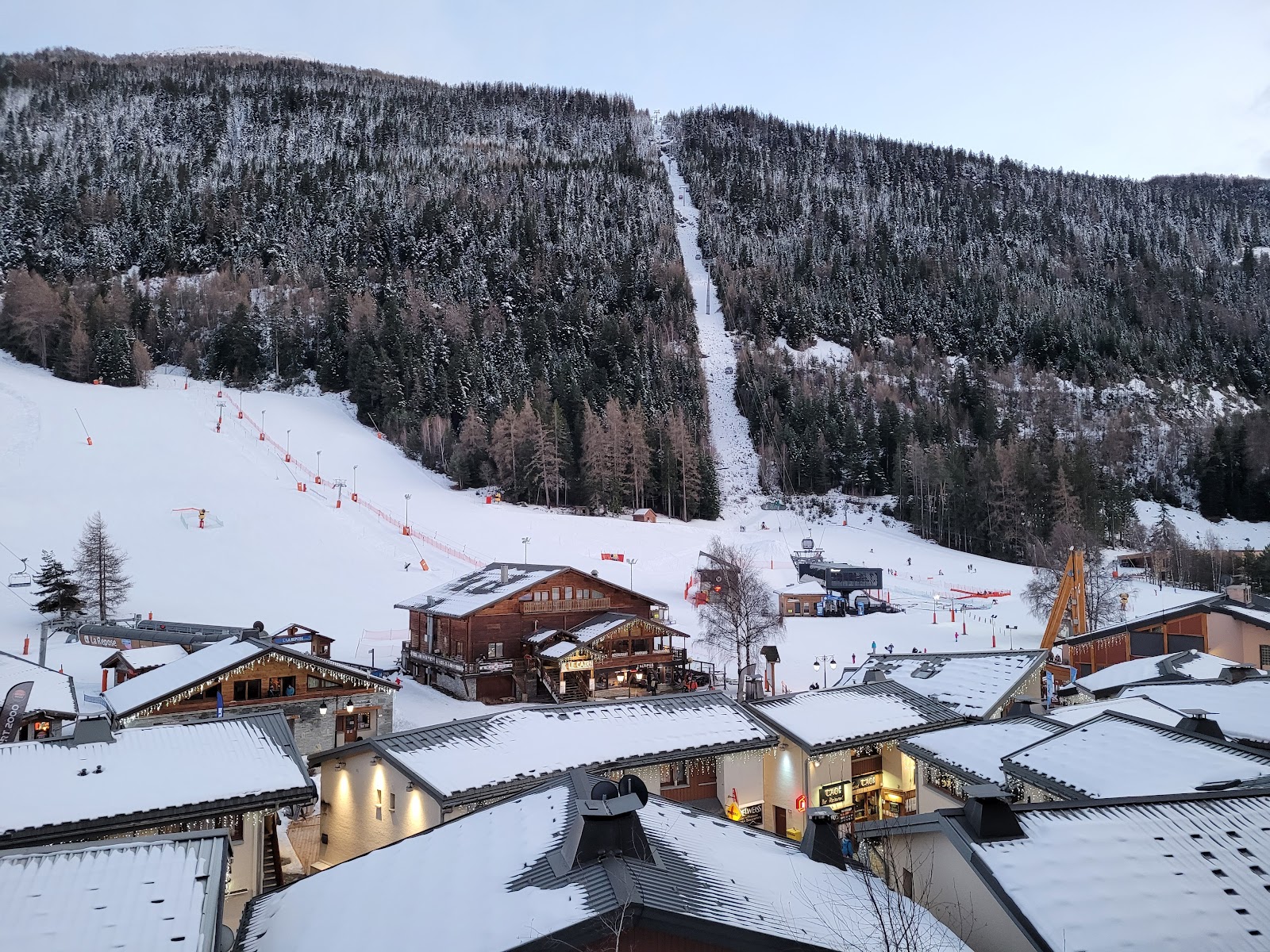 Snow covered apartment buildings at the foot of the La Norma slopes
