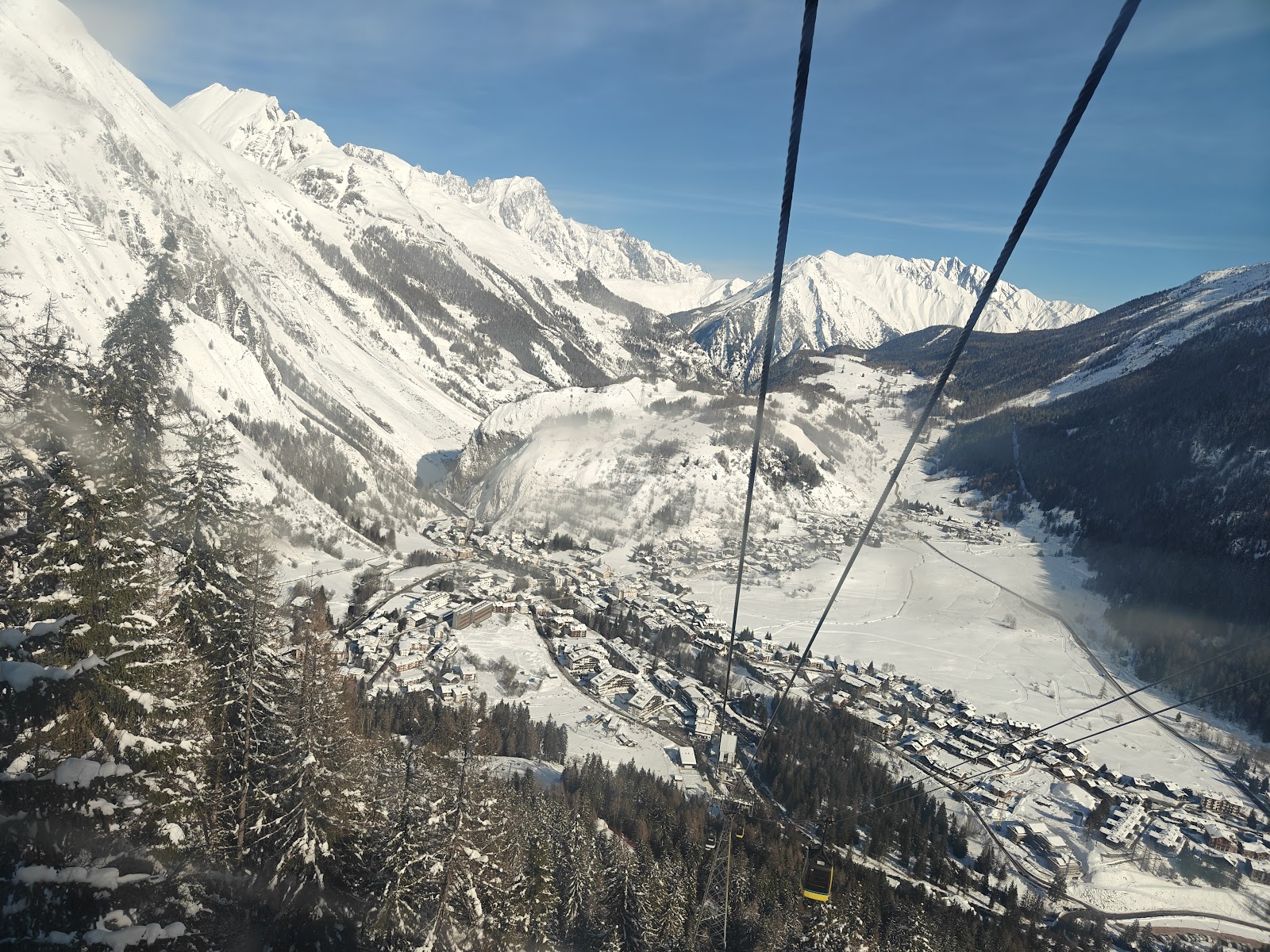 Skiers crossing the ridge between La Thuile and La Rosiere on the cross border link