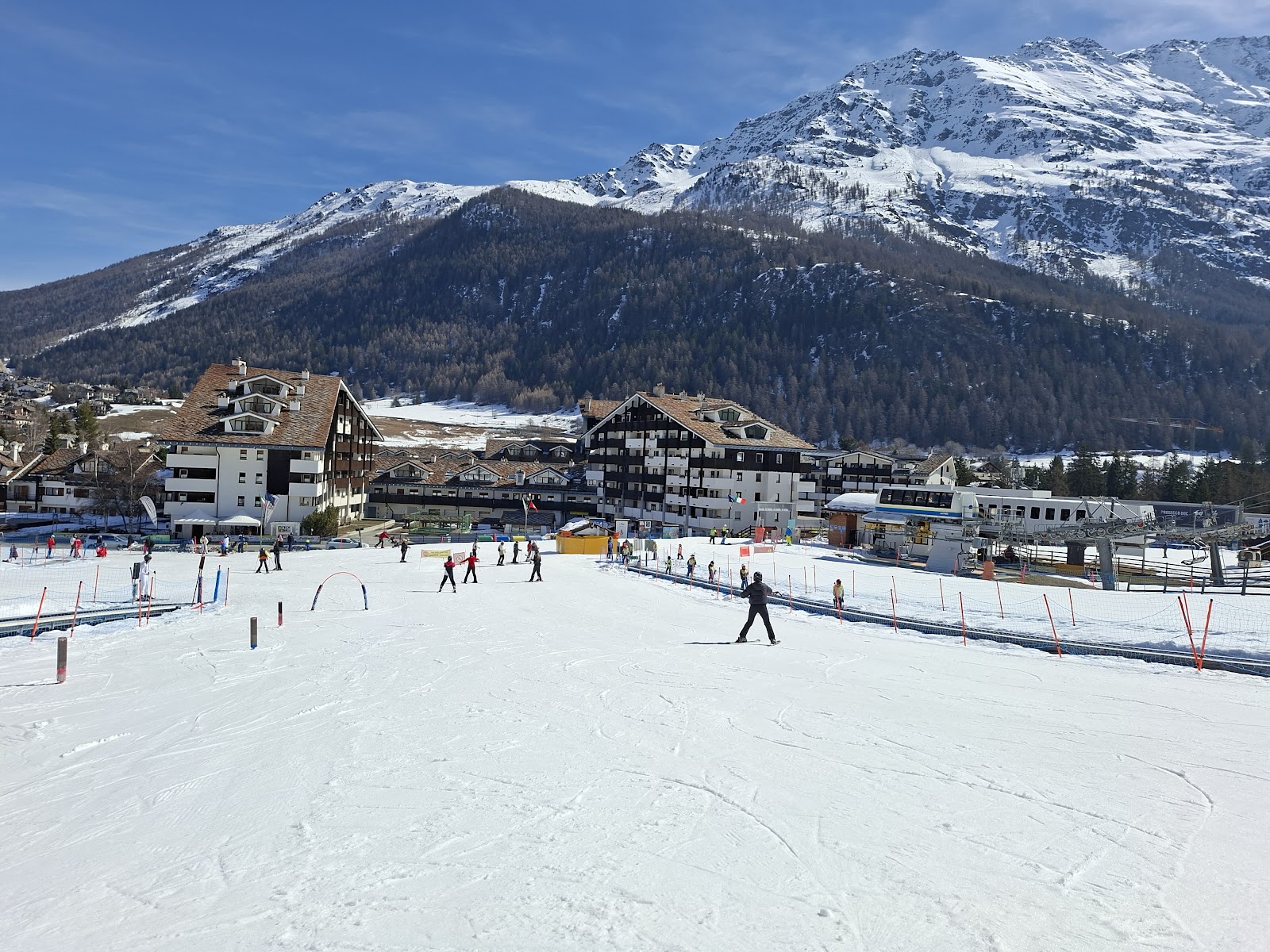 A steep black race piste above La Thuile dropping toward the valley