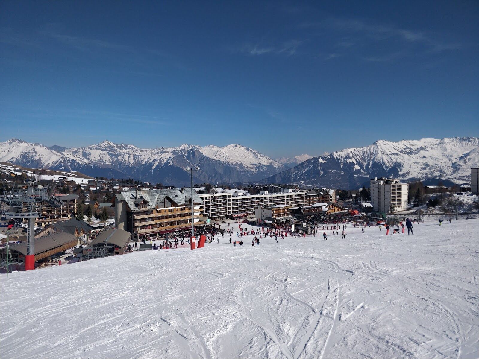 The open plateau village of La Toussuire spread across the snowfield in winter sun