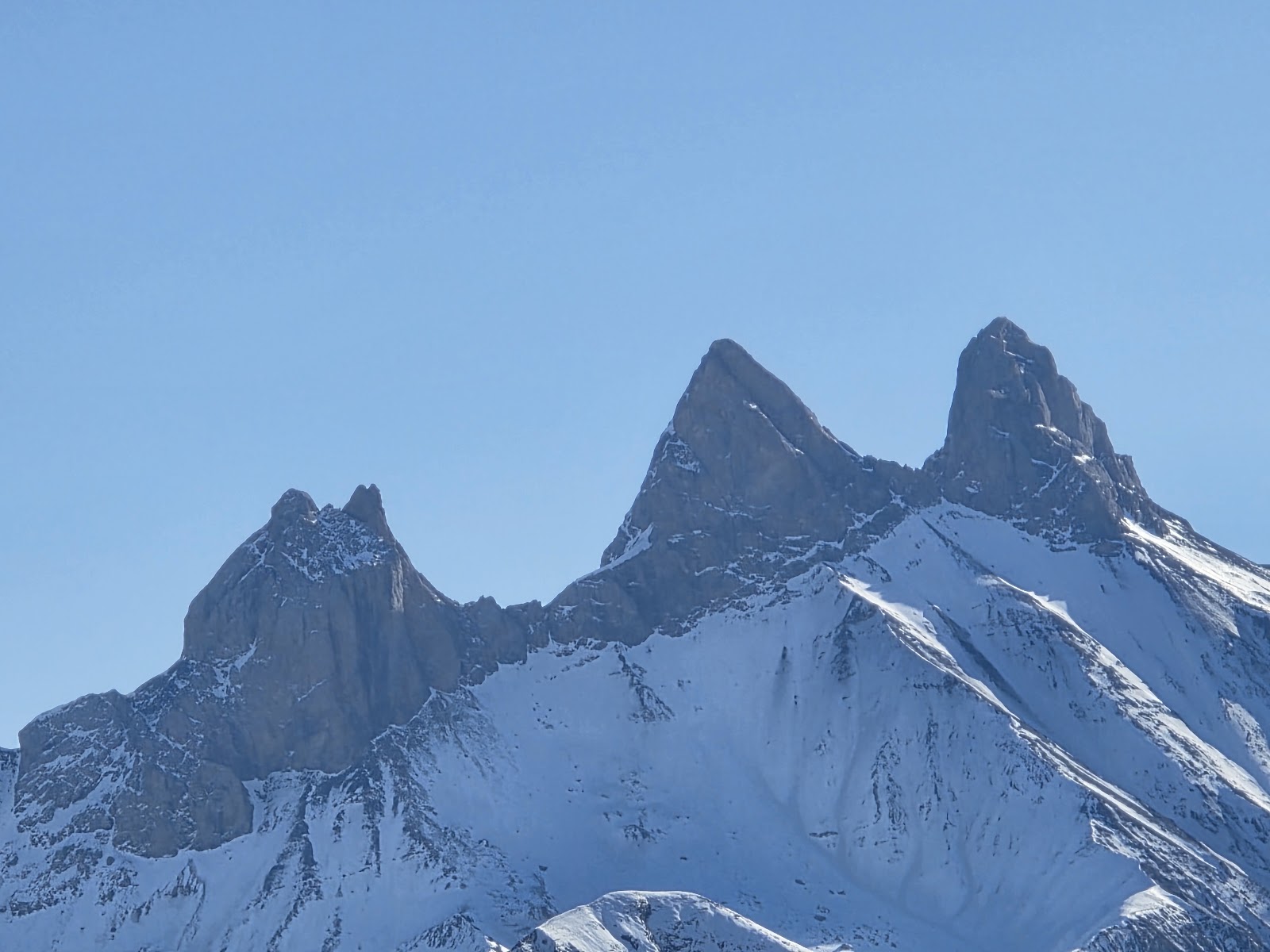 Wide gentle pistes above La Toussuire with skiers cruising in good light