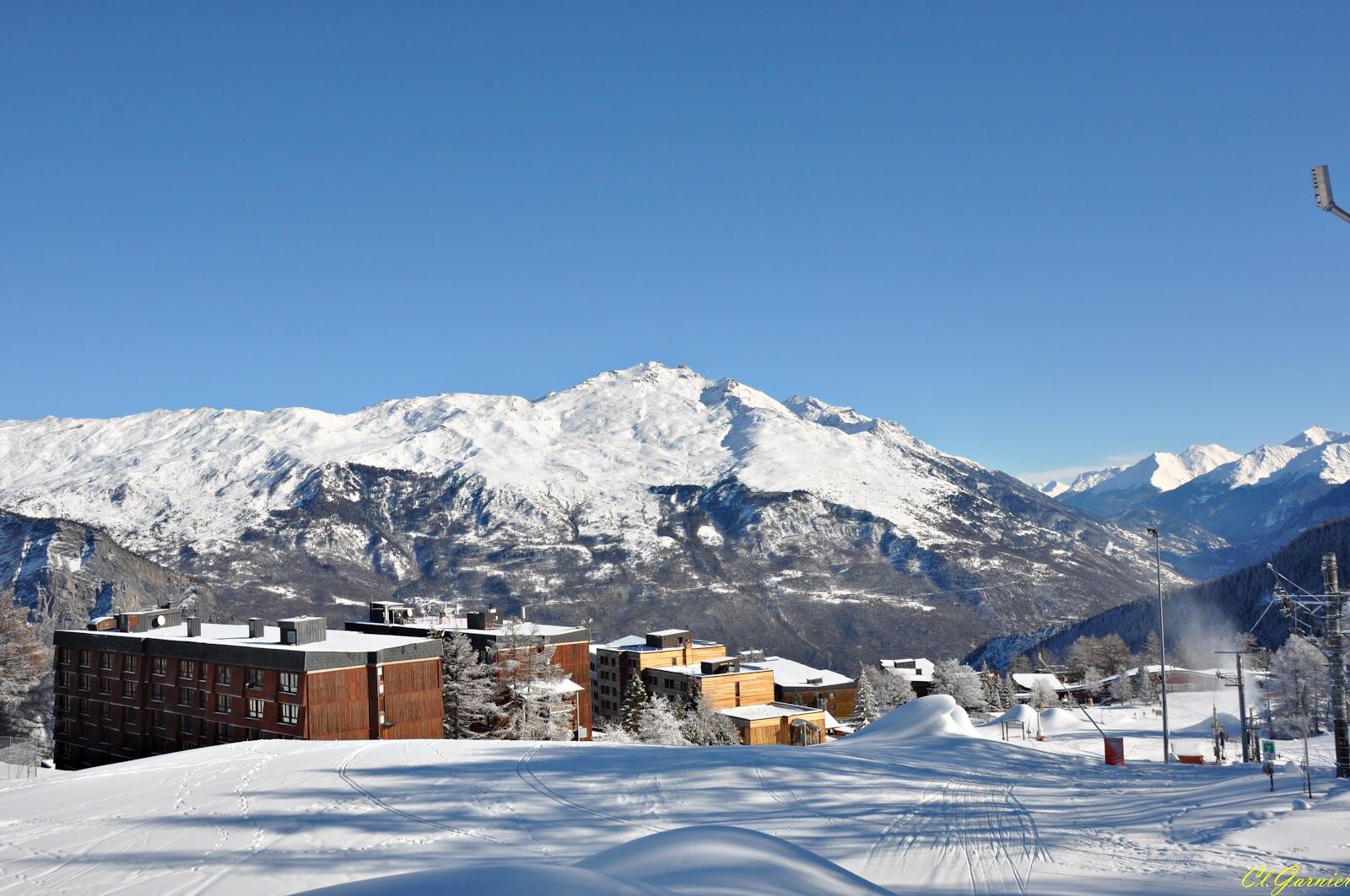 Snow covered mountains above the resort in winter sun