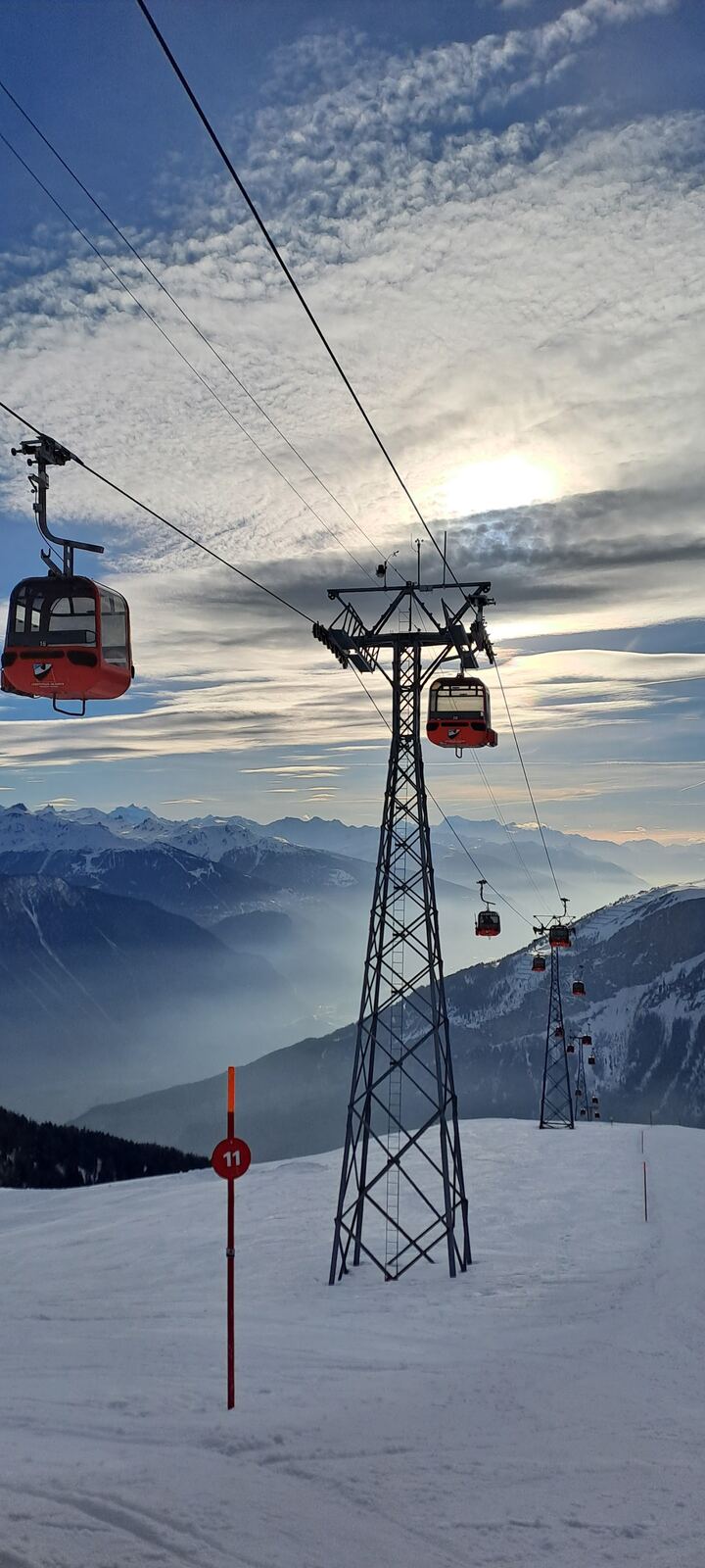Groomed pistes of the Torrent ski area above Leukerbad with Valais peaks behind