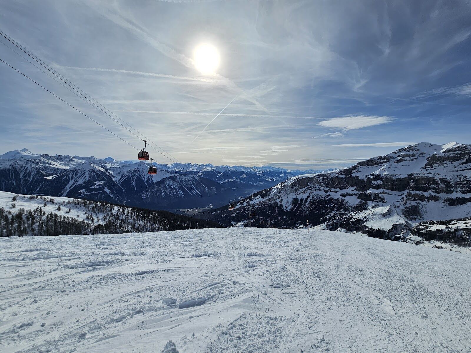 Steam rising from outdoor thermal pools in the snow at Leukerbad