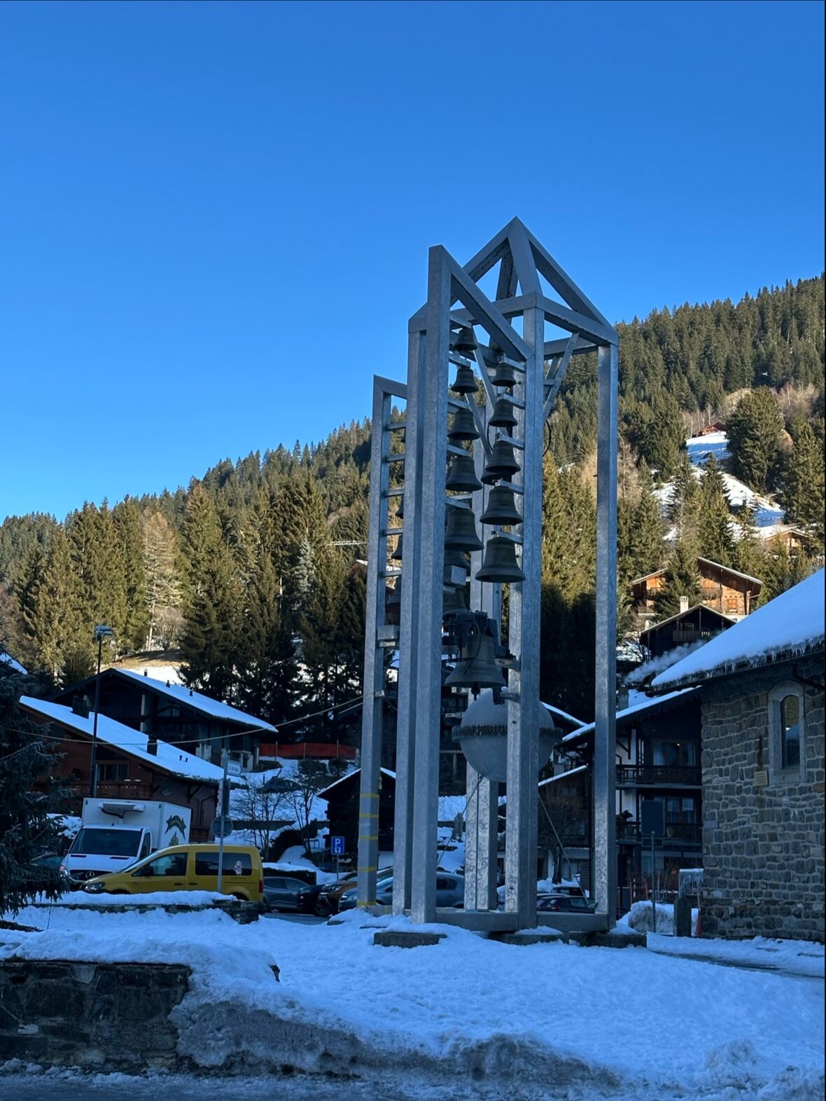 Chalets of Morgins village under wooded slopes in winter
