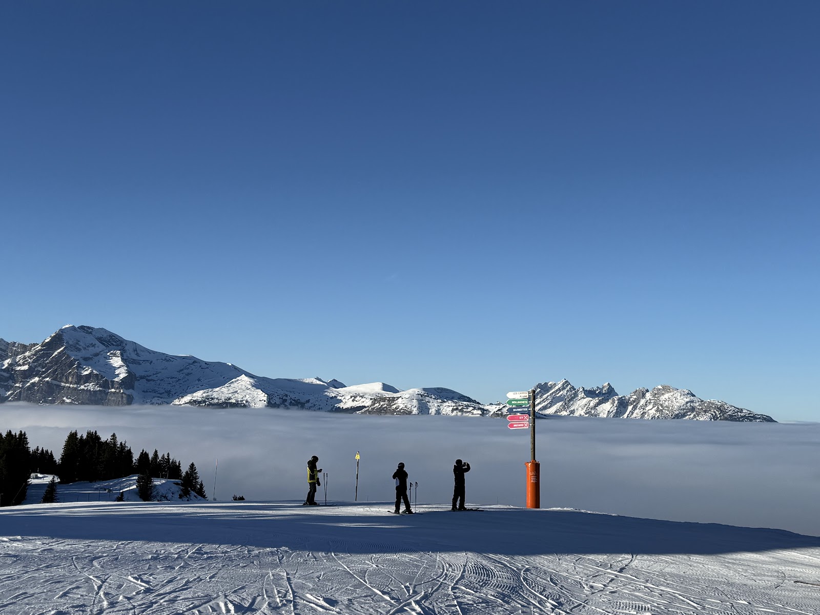 A wide gentle groomed piste through the trees above Morillon