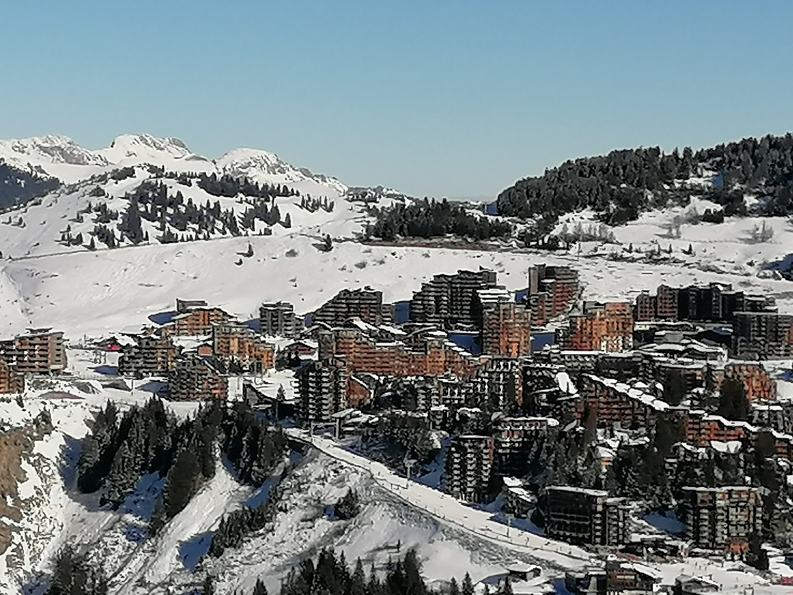 Traditional Haute Savoie ski town with timber buildings under snow