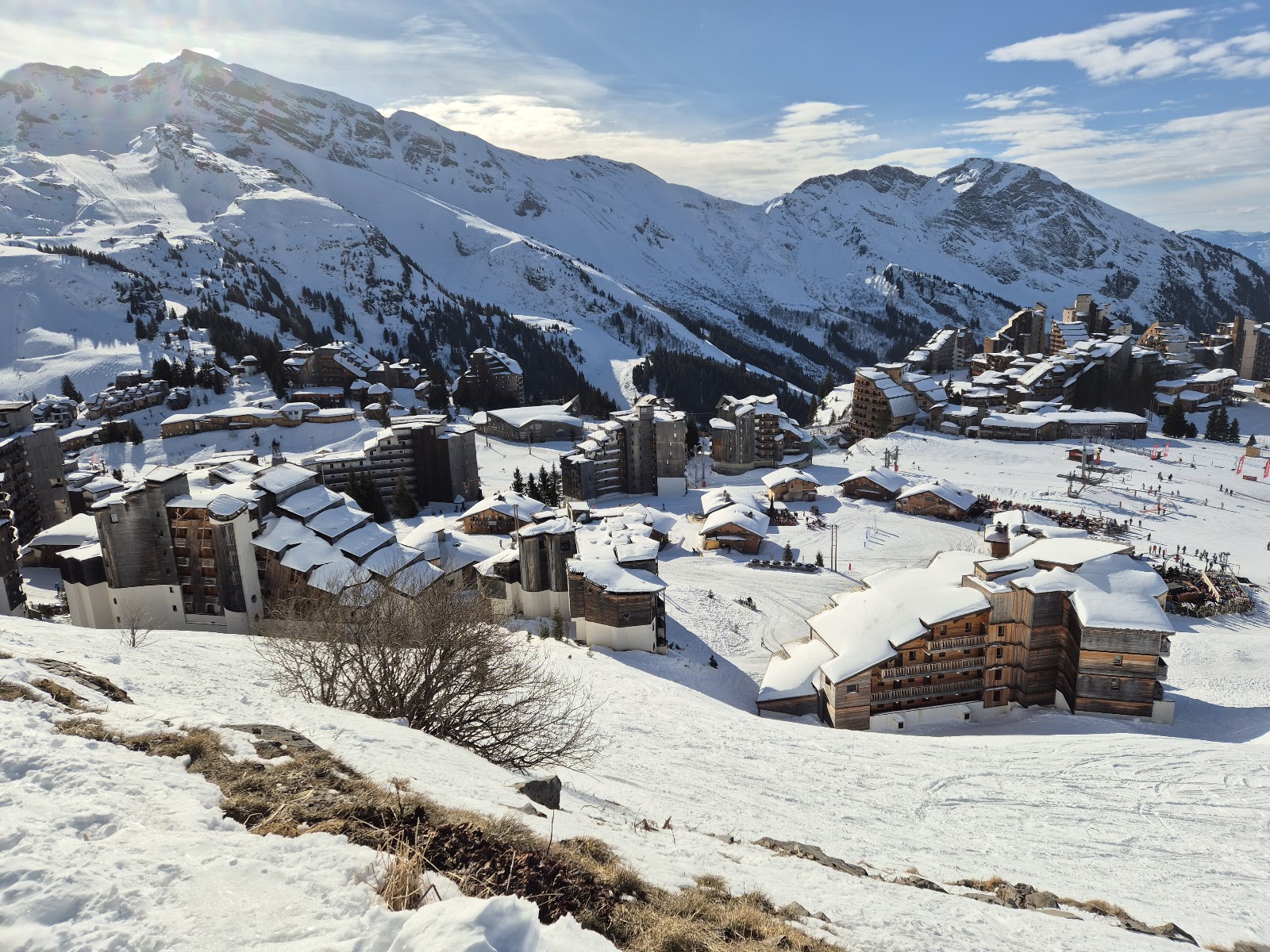 Lively apres ski terrace with people in the sun in a mountain resort