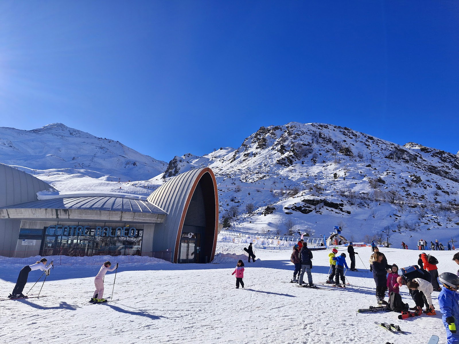 Skiers on a wide sunny piste above Piau Engaly near the Spanish border