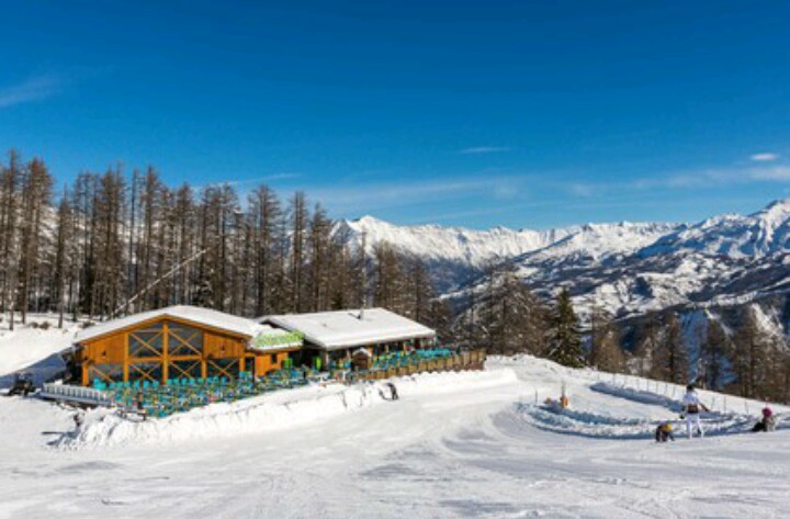 Skiers on the Espace Lumiere slopes above the Ubaye valley