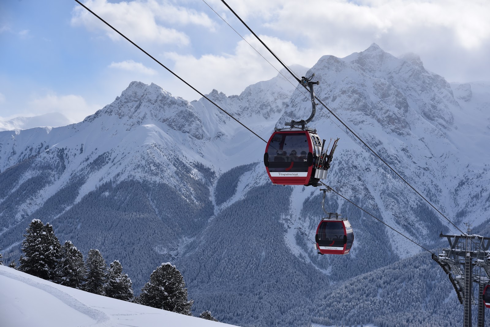 The sunny old town of Scuol below its ski mountain in winter