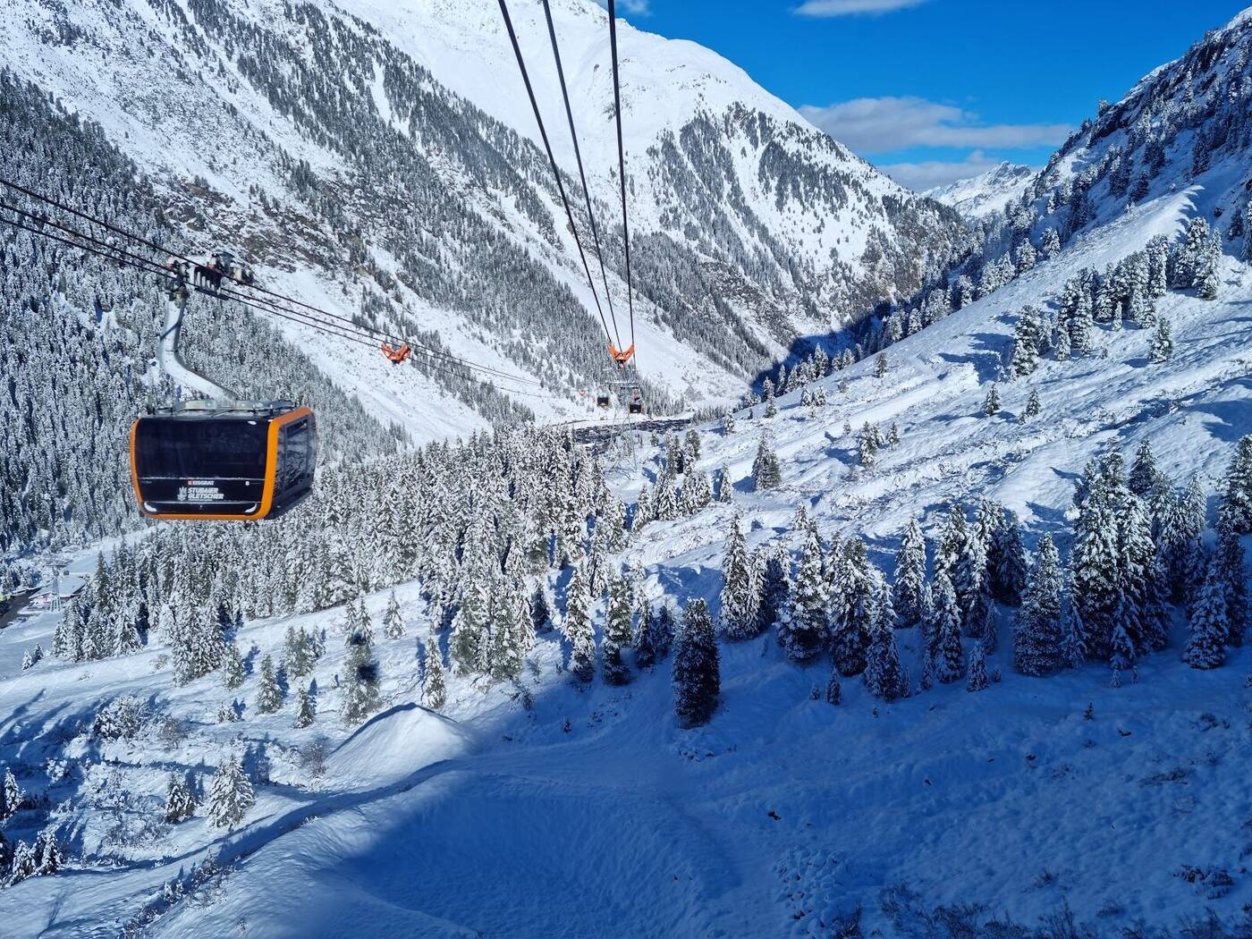 Skiers and big mountain views on the Stubai Glacier