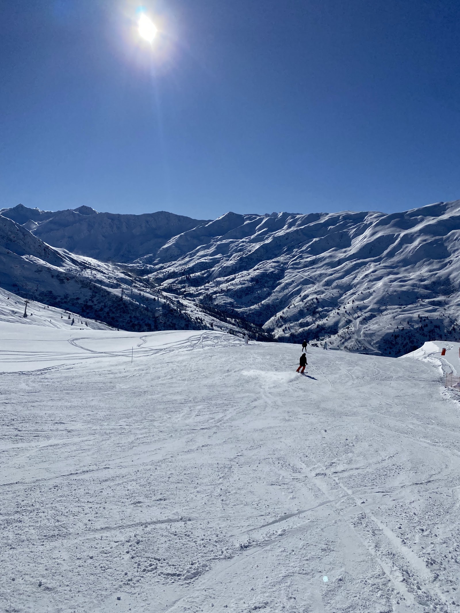 Sunny groomed pistes above the resort of Valmeinier