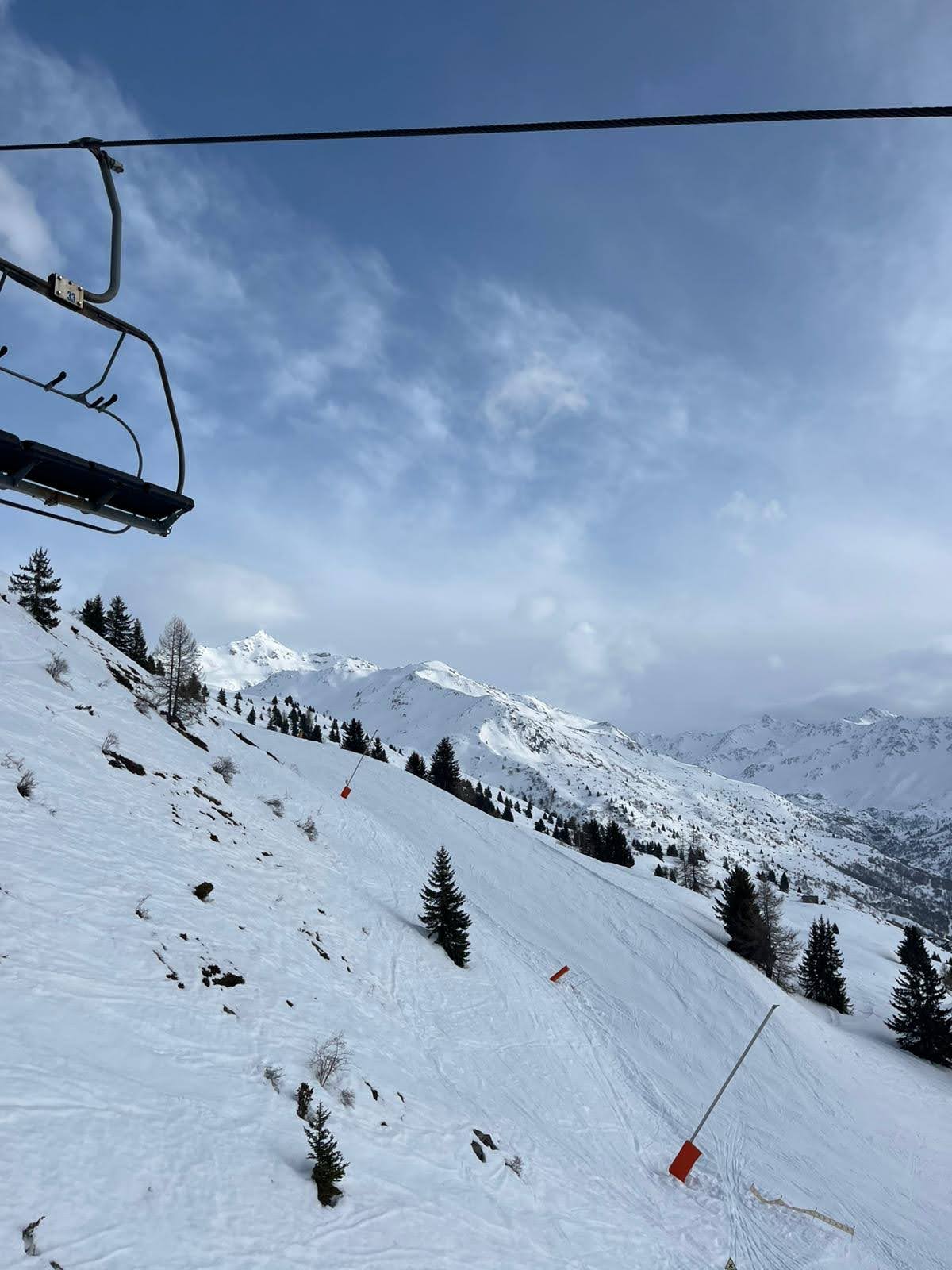 Skiers on a red run in the Galibier Thabor ski area