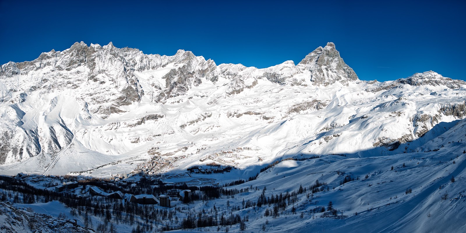 Snowy slopes above the village of Valtournenche under the Matterhorn